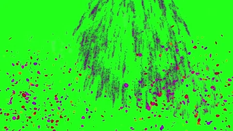 Vibrant purple fireworks exploding over green field. Colorful night celebration Видео 340380950