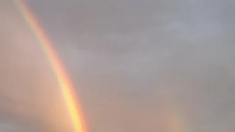 Vibrant rainbow arc appears in the sky after a rain shower Видео 340631566