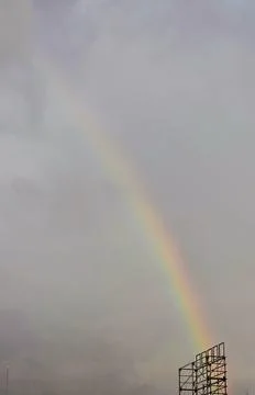 A vibrant rainbow arching across the sky after rain, with its vivid spectru.. Stock Photos