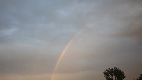 Vibrant rainbow arcs across a dramatic sky after a storm Stock Footage 340631482