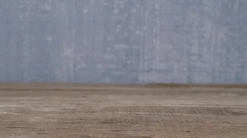 Vibrant red abstract shape displayed on rustic wood, captivating the eye Vidéo 290226577