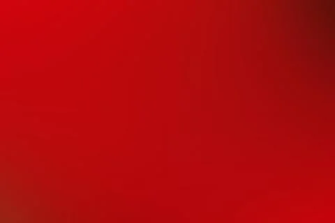 A vibrant red background featuring a captivating gradient effect in the cente Stock Photos
