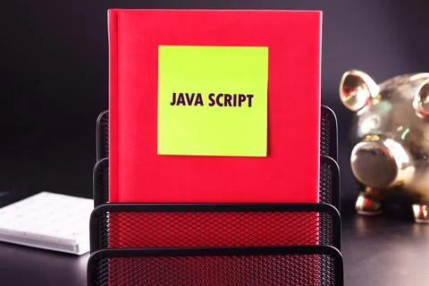 A vibrant red book titled JavaScript stands upright in a black metal organize Stock-Fotos