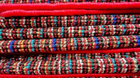 Vibrant Red Colorful Patterned Woven Doormat Stack Stock Photos