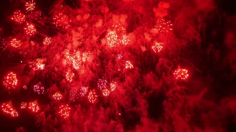 Vibrant red fireworks exploding in night sky with smoke and sparks 스톡 동영상 334127424