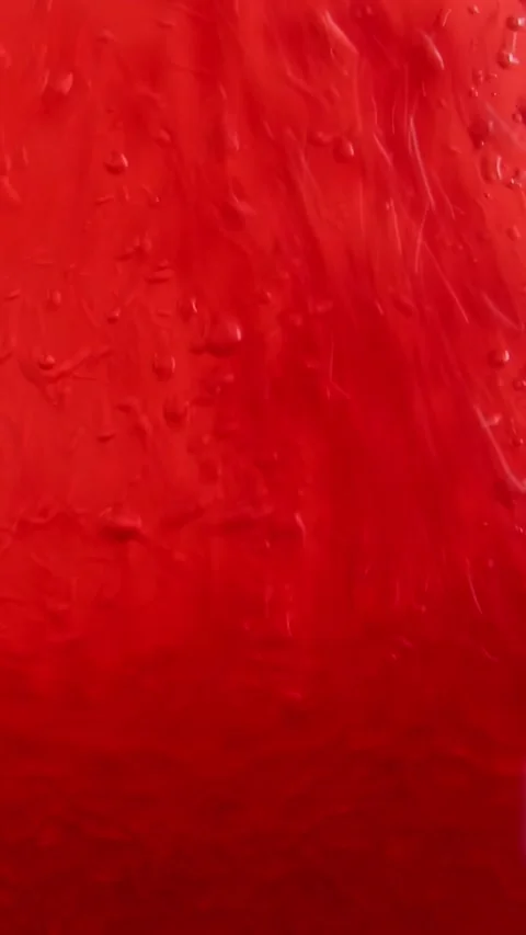 Vibrant red liquid paint flowing and shifting against dark background Видео 311830011