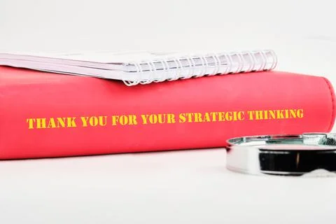 A vibrant red notebook rests on a clean workspace. The cover features a mes.. Stock Photos