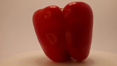 Vibrant red pepper captured in stunning detail highlighting its unique shape and Stock Footage 328634173