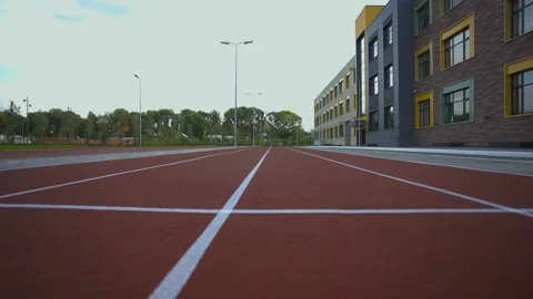 Vibrant red running track with smooth surface at stadium Stock Footage 279134061