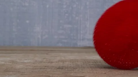 A Vibrant Red Sphere Displayed on a Beautiful Wooden Surface for Visual Appeal 스톡 동영상 290226544