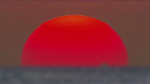 Vibrant Red Sun Setting Over Horizon in Timelapse Stock Footage 327268330