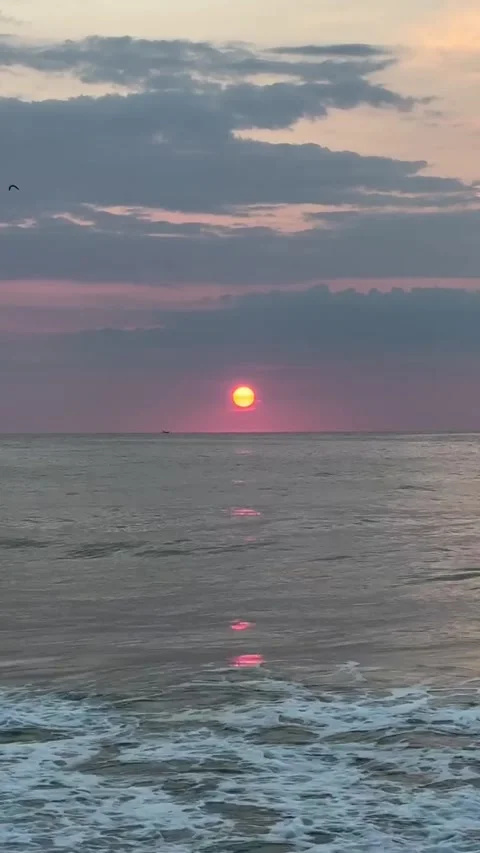 Vibrant Red Sun Setting Over Ocean Waves Stock Footage 340868519