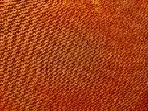 Vibrant rusty orange denim texture closeup showcasing woven patterns subtle g Stock-Fotos