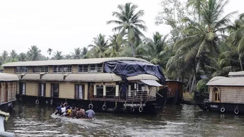A vibrant scene in the backwaters of Kochi showing traditional wooden house Stock Footage 310937352