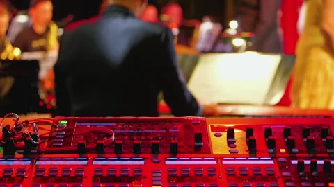 A vibrant scene showcasing a music control board illuminated in red hues Video stock 306819034