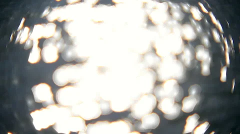 Vibrant sea of playing white flecks on gray water surface background Stock Footage 58212822