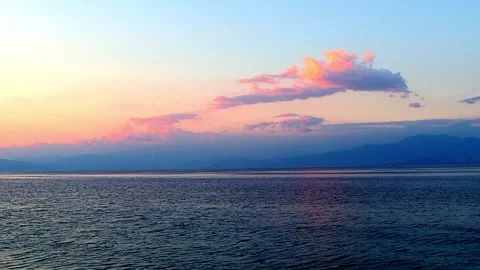 Vibrant seaside sky during late afternoon, with blue, orange, and pink hues. Stock Footage 315435304
