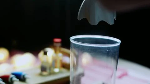 Vibrant serving study of cracking eggs into a tall mixing cup 스톡 사진