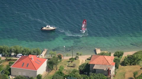 Vibrant shot of a windsurfer making a turn, top view Stock Footage 55868499