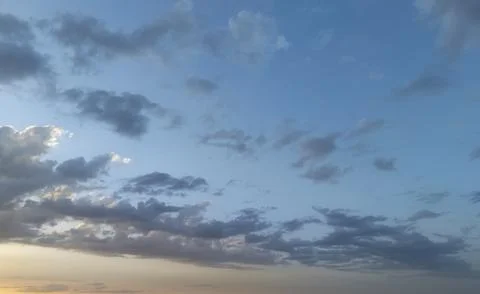 Vibrant sky filled with dynamic clouds at sunset, showcasing a beautiful blend Stock Photos