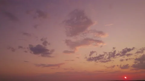 A vibrant skyscape with sun rays, a flight during sundown. Aerial shot of the Stock Footage 203727231