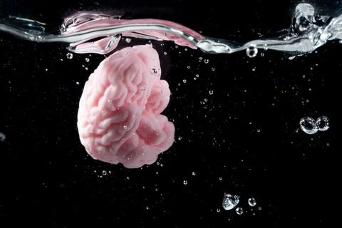 Vibrant Splash of a Pink Brain Symbolizing Mind Energy and Vigor in Water Stock Photos
