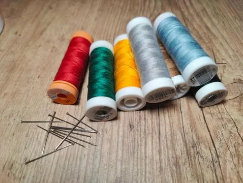 Vibrant spools of thread and sewing pins Stock Photos