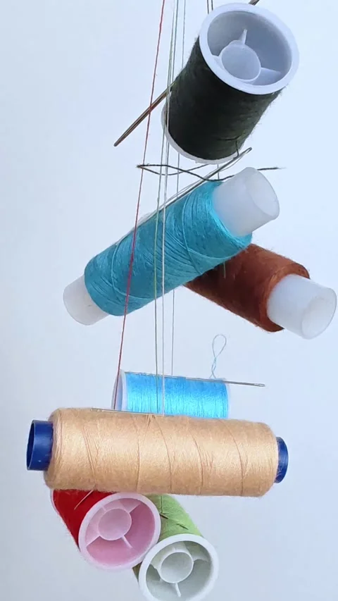 Vibrant spools of thread, needles for sewing and crafting. Stock Footage 309947622