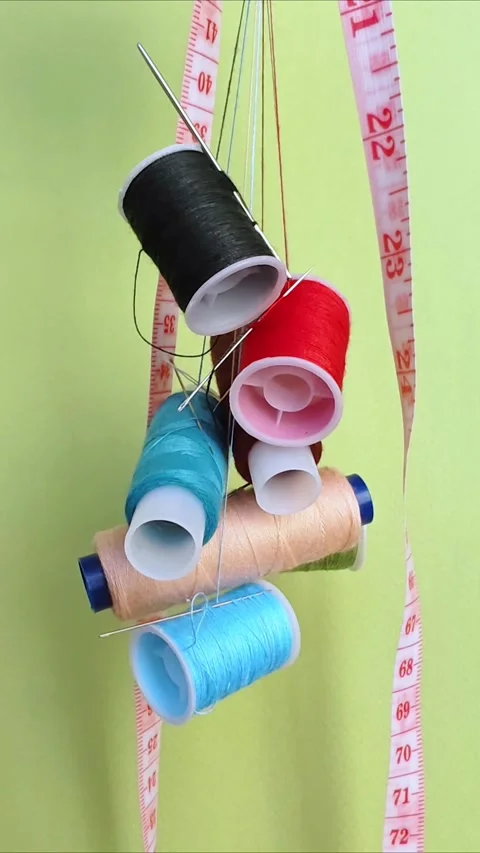 Vibrant spools of thread, needles for sewing and crafting. Video stock 309948590