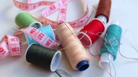 Vibrant spools of thread, needles for sewing and crafting. Video stock 309949141