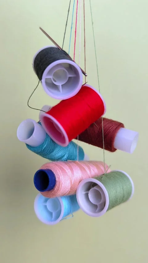 Vibrant spools of thread, needles for sewing and crafting. Video stock 310120719