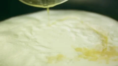 Vibrant spoon coating roasted poultry with pale gravy in tabletop, 4K Stock Footage 341105807