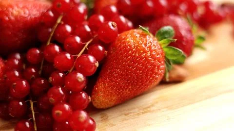 Vibrant spread of fresh berries on rustic wooden table, perfect for eco Stock Photos