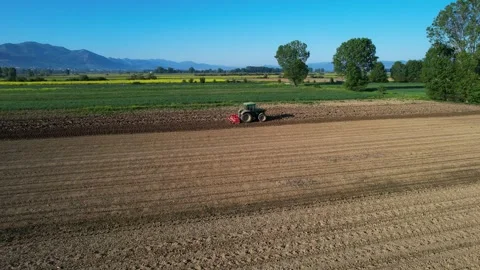 Vibrant Spring Parcels: Fields of Agricultural Farms with Tractor Stock Footage 274727257