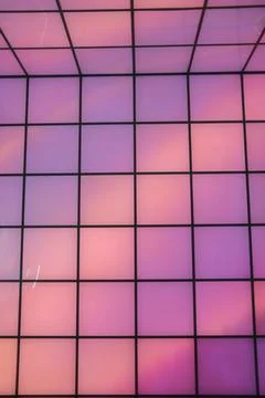 Vibrant square grid illuminated with glowing pink and purple colors Stock Photos