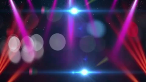 Vibrant stage lights shine down with sparkling particles and soft bokeh effects 스톡 동영상 335668500