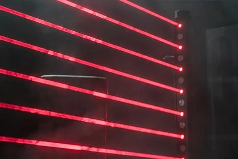 Vibrant stage setup with dynamic red lighting creating vertical beams, possib Stock Photos