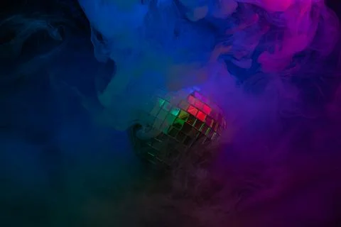 Vibrant stock image showcasing a disco ball at the center of a dynamic swir.. Stock Photos