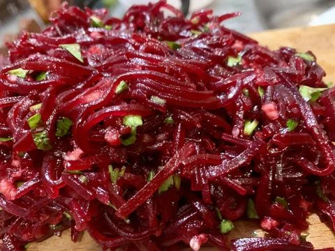 Vibrant strands of beetroot mixed with finely chopped herbs create a colorful Stock Photos