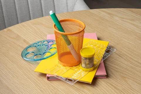 A vibrant study setup featuring colorful stationery on a wooden table. Stock Photos