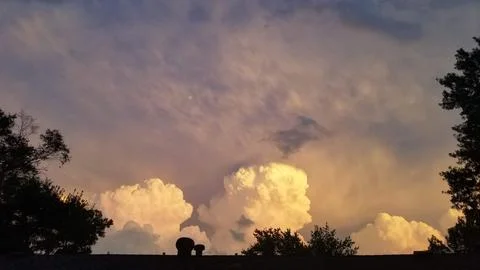 Vibrant sunburst breaking through dramatic sunset clouds 스톡 사진