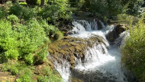 Vibrant Sunlit Cascade: Small Mossy Waterfall on the Krka River Video stock 347015692