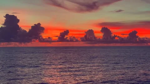 Vibrant sunrise over the ocean with dramatic clouds on the horizon and colo.. Stock Footage 338281664