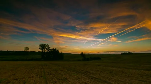 Vibrant sunrise sky over fields in 4k time lapse. Stock Footage 154414979