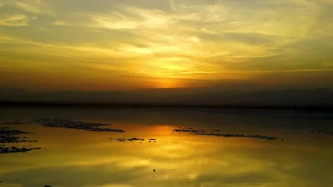 Vibrant sunset and reflection over salt flats in Danakil Depression, Stock Footage 196139646