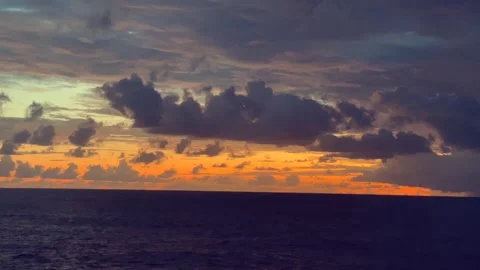 Vibrant sunset with dramatic clouds over a calm ocean Stock Footage 338281711