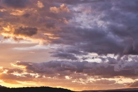 Vibrant Sunset with Dramatic Clouds Stock Photos