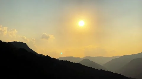 Vibrant Sunset Illuminating Clouds and Mountain Silhouettes in China 動画素材 334705427