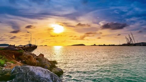Vibrant Sunset over Calm Harbor with Rocky Shoreline Stock Footage 310217138