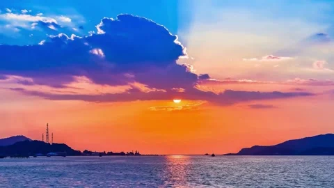 Vibrant Sunset over Calm Ocean Waters and Silhouetted Islands Stock Footage 310245196